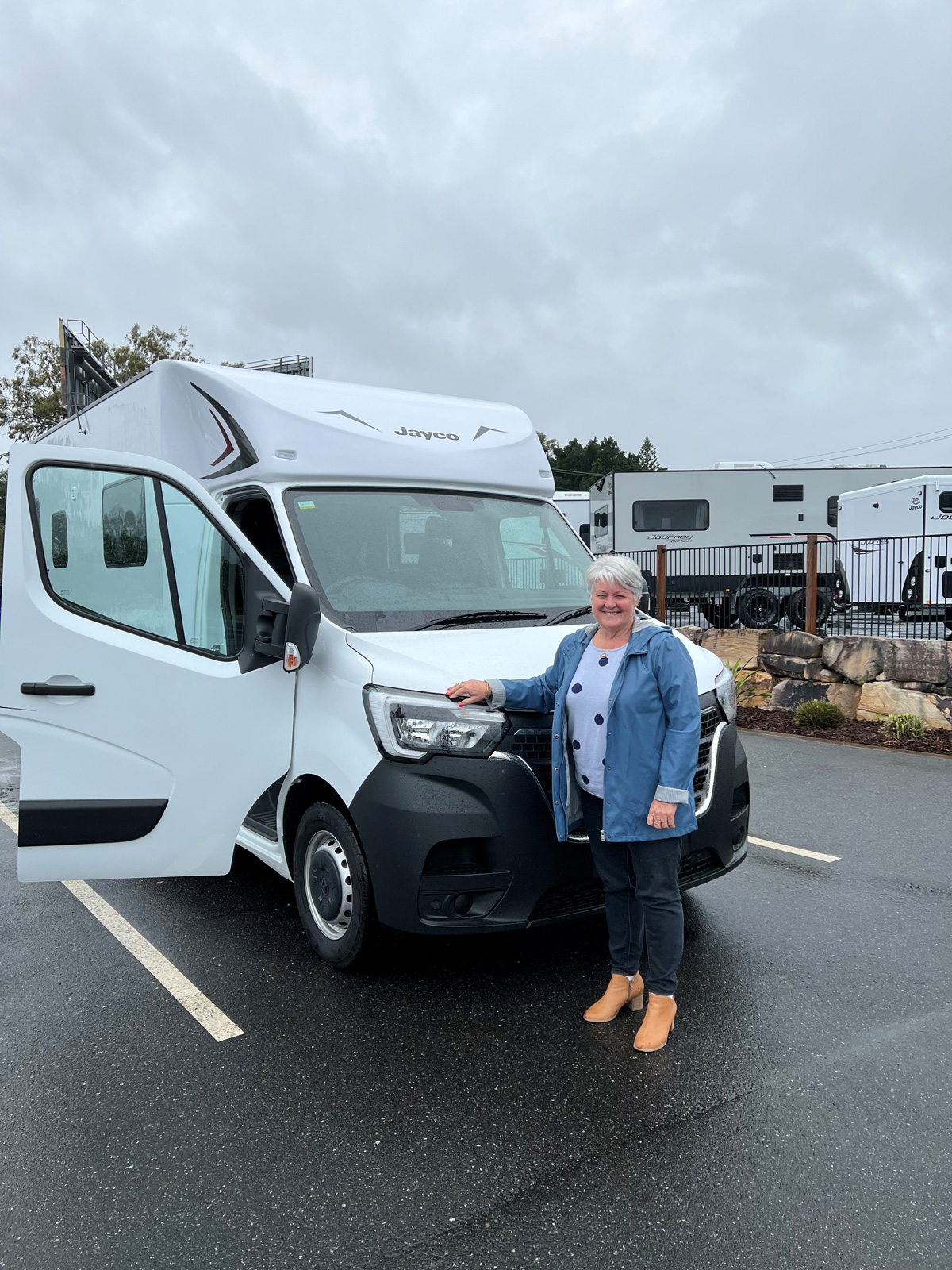 Sue standing in front of her new camper van